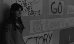 A student stands beside cheer banners at North in 1971.