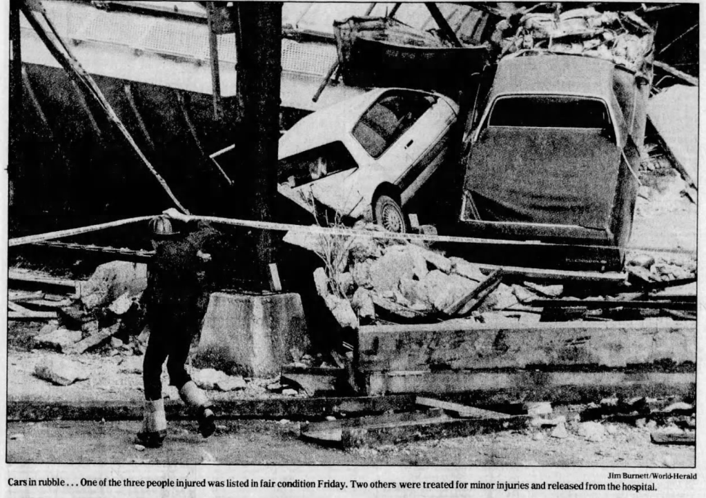 This picture shows a rescue worker standing by wrecked cars at the bottom of the Locust Street Viaduct after a crash by runaway railroad cars demolished the viaduct in March 1990. The span was demolished soon afterward.